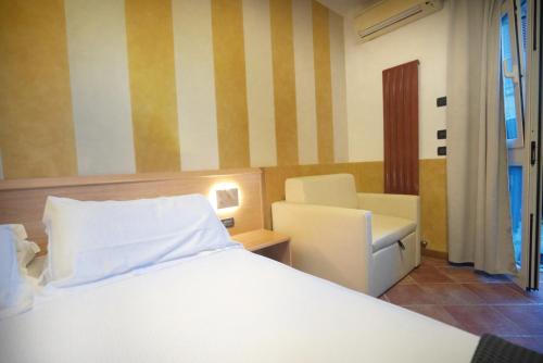 a bedroom with a bed and a desk and a chair at Locanda Ca Da Iride in Riomaggiore
