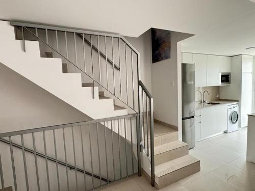 a staircase in a house with a kitchen at Duplex penthouse close to the beach in Costa Ballena