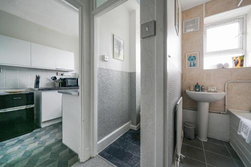 a small kitchen with a sink and a sink at Livestay-Two Bedroom Apartment in Clapham in London