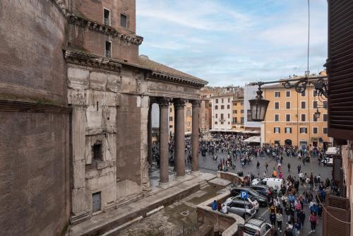 a crowd of people walking down a street in a city at Con il Pantheon fuori dalla finestra - FromHometoRome in Rome