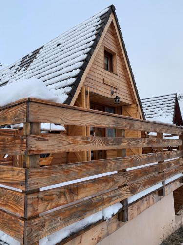 a wooden house with snow on the roof at Chalet 8 à 10 couchages in Le Dévoluy