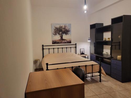 a bedroom with a bed and a table and a desk at Independent and newly built apartment in Kallithea, next to Tavros train station, in a nice neighborhood in Athens