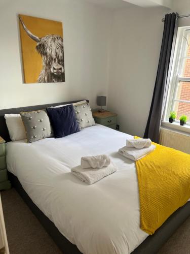 a bedroom with a bed with two towels on it at Russell Square Apartment in Brighton & Hove