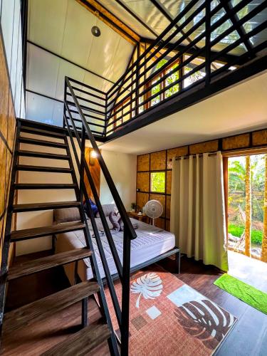 a room with a bunk bed and a staircase at Oasis forest garden in Ban Takuk Nua