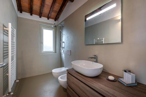 bagno con lavandino, servizi igienici e specchio di YiD Cozy House in Fiesole 5 min from Florence a Fiesole