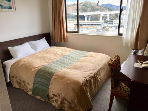a hotel room with a bed and a window at HOTEL GATE 88 in Naruto