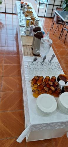 a long table with plates of food on it at Pousada Felix in São Gabriel