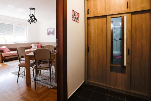 a living room with a table and a dining room at Apartman Andrea in Lukavica