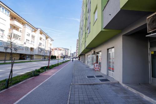 an empty street in a city with buildings at Apartman Andrea in Lukavica