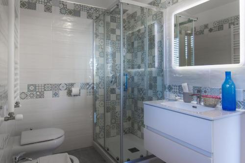 a bathroom with a shower and a toilet and a sink at Villa Fontana Limite in Vietri sul Mare
