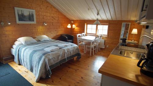 a bedroom with a bed and a kitchen with a sink at Mannflogården Bed & Breakfast , Sälenfjällen in Transtrand