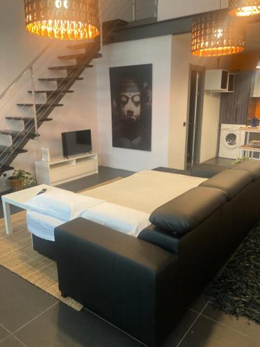a bedroom with a bed and a couch and stairs at Apartamento tipo Loft in Madrid