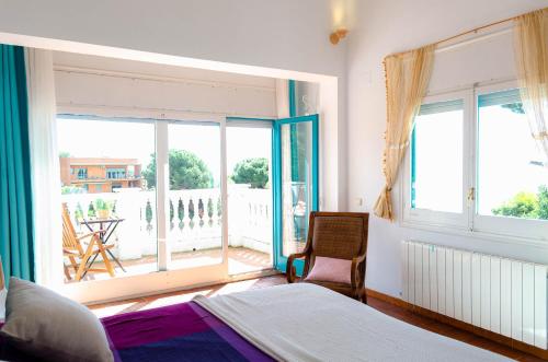 a bedroom with a bed and a view of a balcony at El Riu del Cel in Lloret de Mar