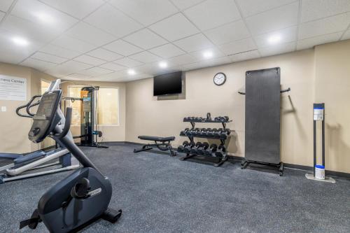 a gym with cardio equipment and a tv in a room at Sleep Inn & Suites in Newport News
