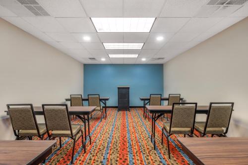 a classroom with tables and chairs and a blue wall at Sleep Inn & Suites in Newport News