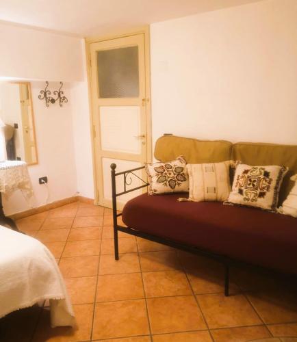a room with a couch with pillows on it at B&B PARNASO in Torre Annunziata