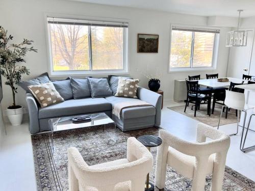 a living room with a couch and a dining room at Crystal City Boutique Flats 2BR - Free Parking 2878 in Arlington