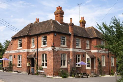 a large red brick building with a roof at Flower Pot Hotel in Henley on Thames