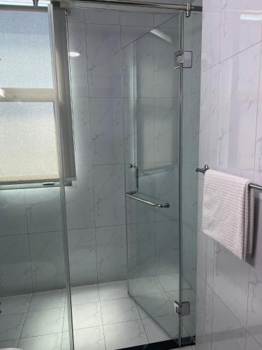 a shower with a glass door in a bathroom at SIRIUS TOWER in Juffair