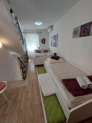 a room with two beds and a couch in it at Sea Holiday Houses in Drasnice