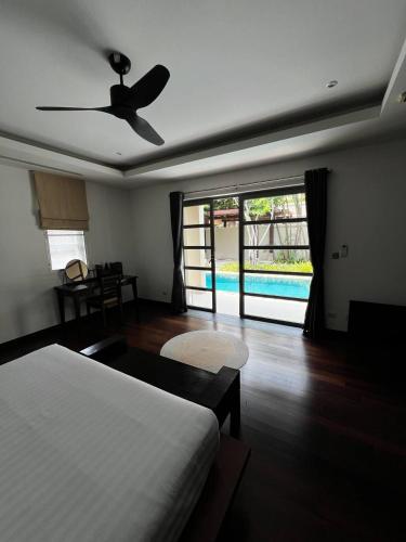 a bedroom with a bed and a ceiling fan at The Residence Resort in Phuket
