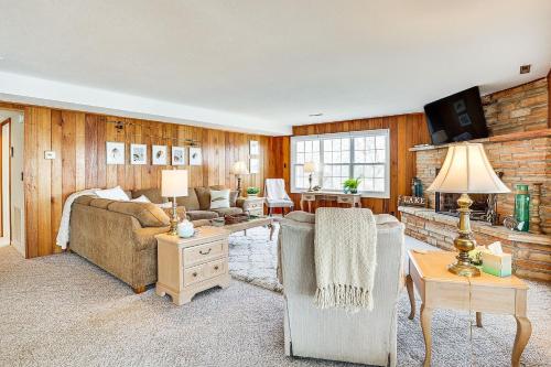 a living room with a couch and a table at Lake of the Ozarks Haven with Decks, Dock and Kayaks! in Roach
