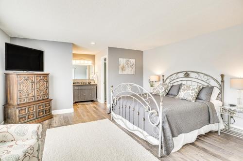 a bedroom with a bed and a tv on a wall at Lake of the Ozarks Haven with Decks, Dock and Kayaks! in Roach