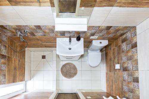 a bathroom with a sink and a toilet at Vila Sonata Palanga in Palanga
