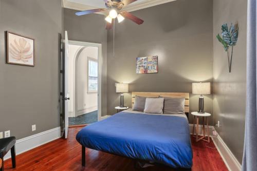 a bedroom with a blue bed and a ceiling fan at 3BD HOME STEPS TO SAINT CHARLES Gated Parking in New Orleans