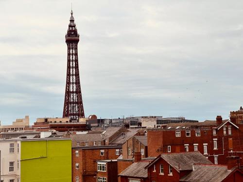 a view of the eiffel tower from the roofs of buildings at Winter Gardens Flat 4 Tower view family apartment in Blackpool