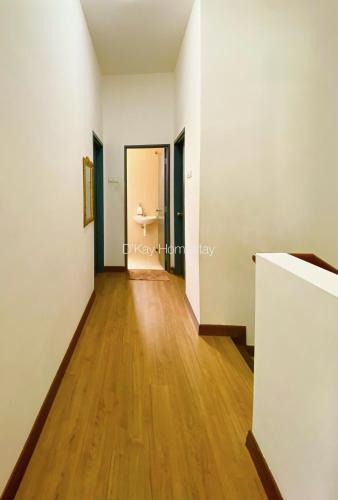 a hallway with white walls and a hard wood floor at 4 Bedrooms Homestay in Ainsdale by D'KAY HOMES, near Seremban2 l 8-12 pax in Seremban