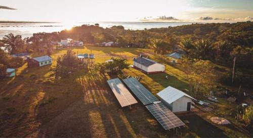 an aerial view of a farm with a solar array at POUSADA DA DRI LODGE in Iranduba