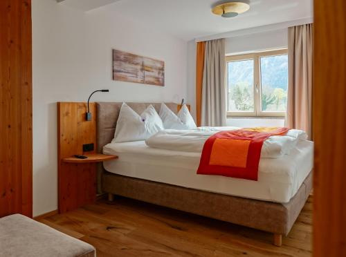 a bedroom with a large bed with a window at Haus Alpenblick in St. Wolfgang