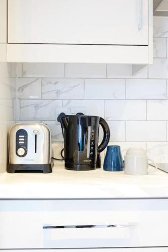 a coffee pot and a toaster on a kitchen counter at The London life in Bricklane in London