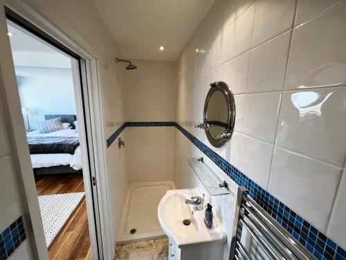 ein kleines Bad mit einem Waschbecken und einem Spiegel in der Unterkunft North Quay in Saint Helens