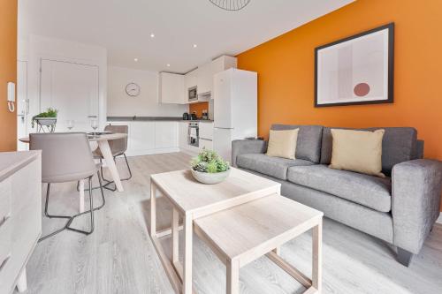 a living room with a couch and a table at StayZeni, Hardwick House Derby Modern 1 Bed Flat in Derby