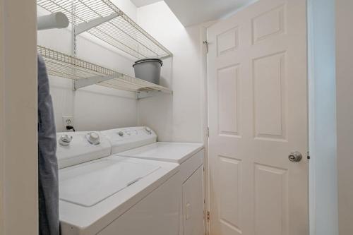 a white laundry room with white counters and a white door at Private Pool & Yard Mins to Dining & University in Mobile