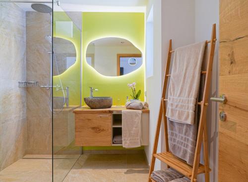 a bathroom with a sink and a shower with a mirror at Haus Alpenblick in St. Wolfgang