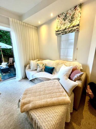 a living room with a couch and a table at The Terrace Garden Flat in Bournemouth