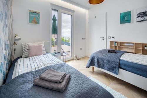 a bedroom with a bed and a large window at Hillside Home in Balatonalmádi