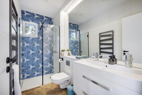 a bathroom with a toilet and a sink and a mirror at Hillside Home in Balatonalmádi