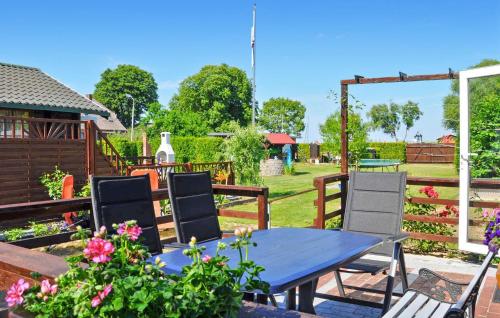 a blue table and chairs in a garden at Ferienhaus Lassan Bei Wolgast in Lassan