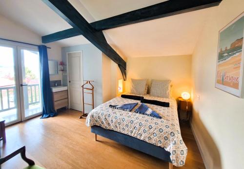 a bedroom with a bed and a large window at Casa Baia Hendaye in Hendaye