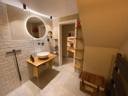 a bathroom with a sink and a mirror at Cosy Getaway in Gostinjac