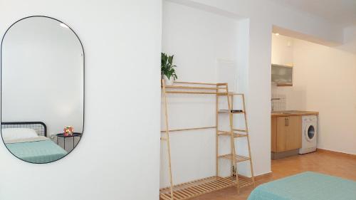a mirror in a room with a bed and a chair at Villa Boukari in Chlomós