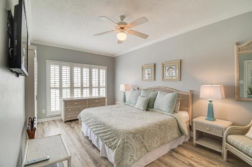 a bedroom with a bed and a ceiling fan at Dolphin Harbor Orange Beach Condo w/ Beach Access! in Orange Beach