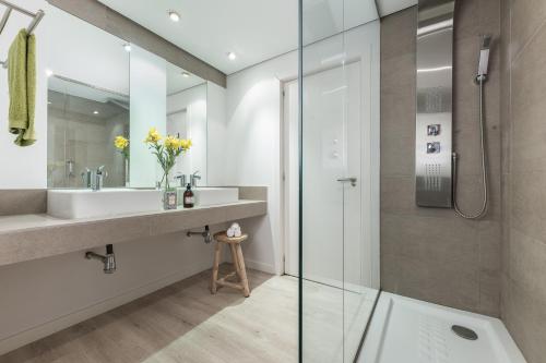 a bathroom with a sink and a shower at Homeclub Apartment at Plaza Colon in Madrid