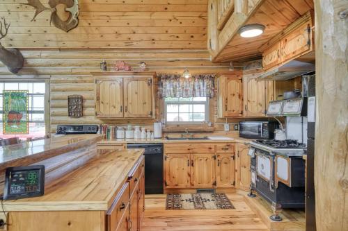 a large kitchen with wooden cabinets and a stove at Uncle Terry's Cabin in Rigby