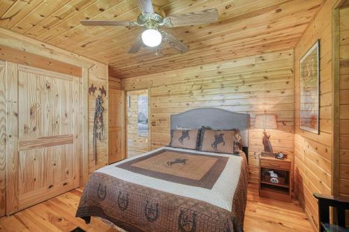 a bedroom with a bed in a log cabin at Uncle Terry's Cabin in Rigby