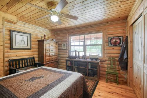 a bedroom with a bed and a ceiling fan at Uncle Terry's Cabin in Rigby